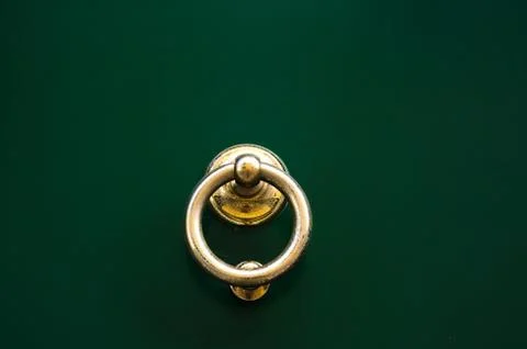 Door with brass knocker in the shape of a decor, beautiful entrance to the ho 스톡 사진