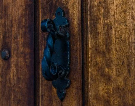 Door with brass knocker in the shape of a decor,  beautiful entrance to the h Stock Photos