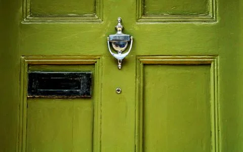 Door with brass knocker in the shape of a hand, beautiful entrance Stock Photos