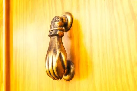Door with brass knocker in the shape of a hand, beautiful entrance Stock Photos