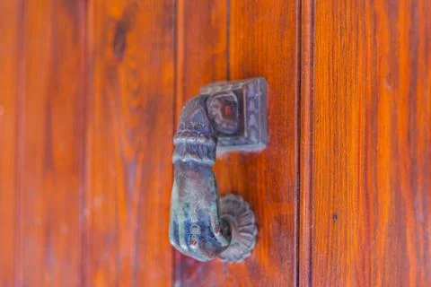 Door with brass knocker in the shape of a hand, beautiful entrance Stock Photos