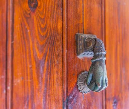 Door with brass knocker in the shape of a hand, beautiful entrance Stock Photos