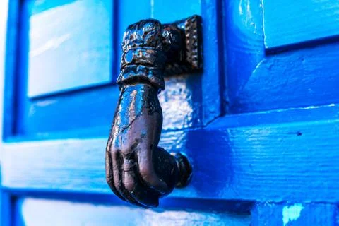 Door with brass knocker in the shape of a hand, beautiful entrance Stock Photos