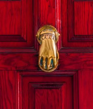 Door with brass knocker in the shape of a hand,  beautiful entrance to the ho Stock Photos