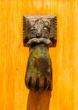Door with brass knocker in the shape of a hand,  beautiful entrance to the ho Stock Photos