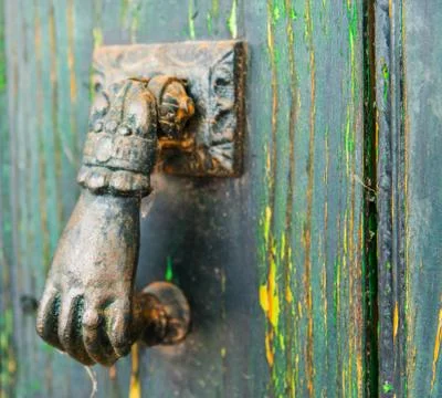 Door with brass knocker in the shape of a hand,  beautiful entrance to the ho Stock Photos