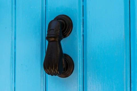 Door with brass knocker in the shape of a hand,  beautiful entrance to the ho Stock Photos