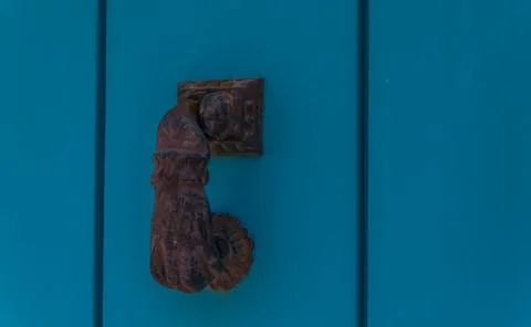 Door with brass knocker in the shape of a hand,  beautiful entrance to the ho Stock Photos