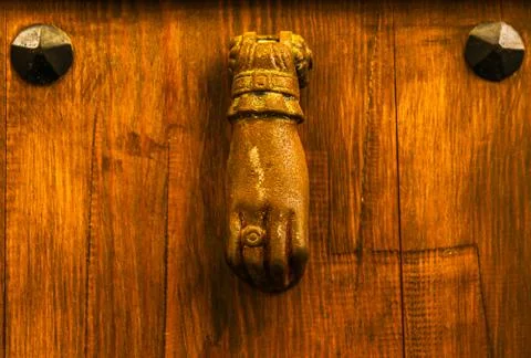 Door with brass knocker in the shape of a hand,  beautiful entrance to the ho Stock Photos