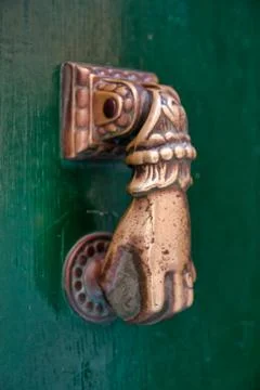 Door with brass knocker in the shape of a hand. 스톡 사진