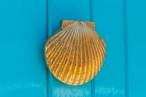 Door with brass knocker in the shape of a shell,  beautiful entrance to the h Stock Photos