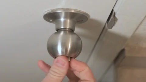 Door closes, hand locks it, doorknob shaking Stock Footage 101268924