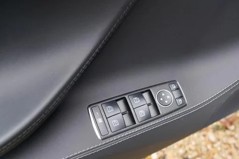 Door control panel in a new modern car electric window button Photos