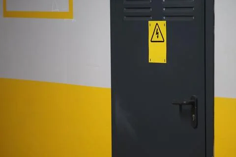 A door displaying a warning sign within a facility setting Фото