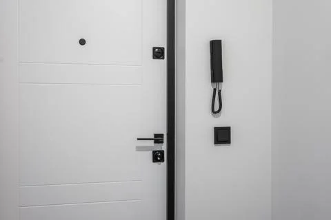 Door handle and light switch next to it in a bright room or office 스톡 사진