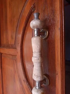 A door handle and lock embedded in the brown door Stock Photos
