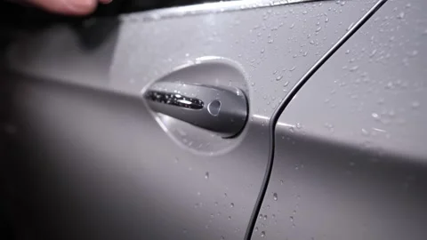 The door handle of a gray car, for which the hand is taken and opens the door. Video stock 240727475