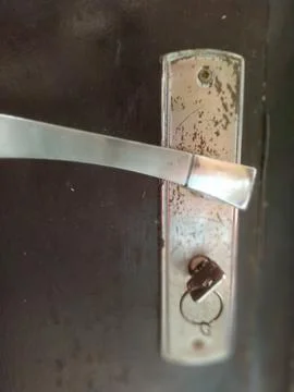 The door handle has a key in the lock for easy access to the door, commonly u Stock Photos