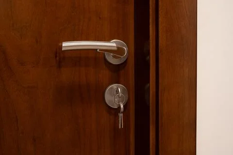 Door handle with key in lock Stock Photos