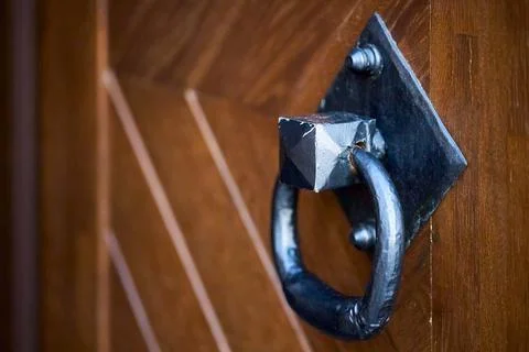 Door handle knocker selective focus on brown old wooden church entrance door Stock Photos