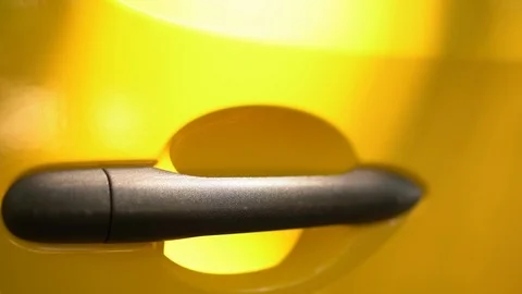 Door handle made of plastic on yellow car door Stock Footage 126304345