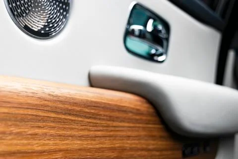 Door handle with power window control buttons of a luxury passenger car. Whit Photos