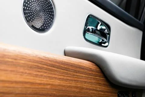 Door handle with power window control buttons of a luxury passenger car. Whit Stock Photos