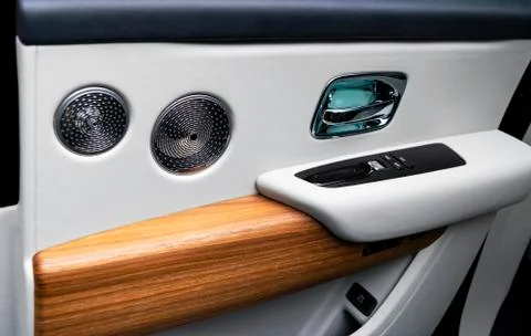Door handle with power window control buttons of a luxury passenger car. Whit Stock Photos