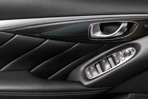Door handle with Power window control buttons of a luxury passenger car. Blac Photos
