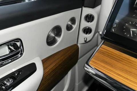 Door handle with power window control buttons of a luxury passenger car. Wh.. Stock Photos