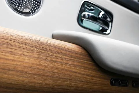 Door handle with power window control buttons of a luxury passenger car. Wh.. Stock Photos