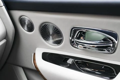Door handle with power window control buttons of a luxury passenger car. Wh.. Stock Photos