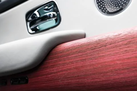 Door handle with power window control buttons of a luxury passenger car. Wh.. Stock Photos