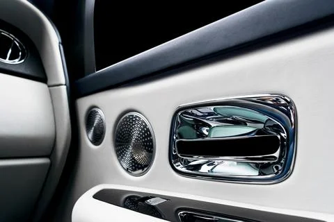 Door handle with power window control buttons of a luxury passenger car. Wh.. Stock Photos