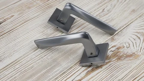 Door handles rotate 360 degrees on a turntable on a wooden background Stock Footage 292377308