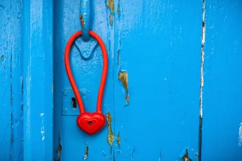 Door with heart shape padlock hanging on handle. Stock Photos