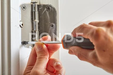 Door hinge installation. Stock Photos