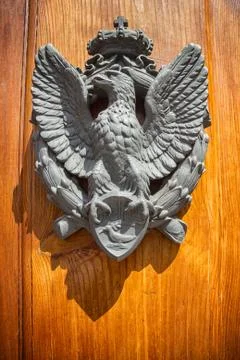 The door to the house with the emblem of an eagle on the shield Stock Photos