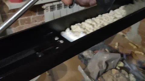 Door installation process. Polyurethane foam is squeezed onto a metal part Stock Footage 145731160