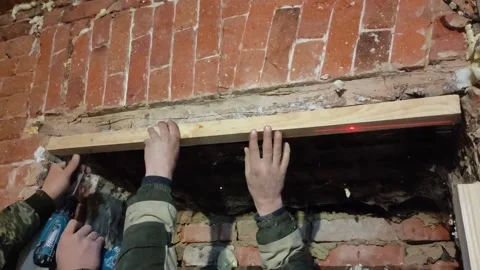 Door installation process. Polyurethane foam is squeezed onto a metal part Stock Footage 145731306