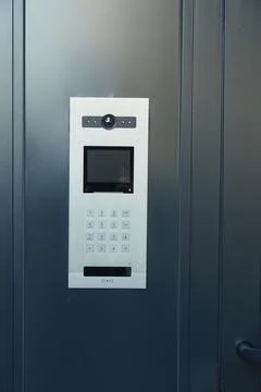 Door intercom system in a modern building entrance Stock Photos