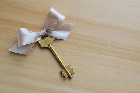 Door key decorated with a bow Stock Photos