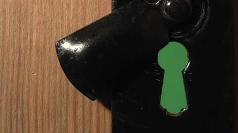 Door with a keyhole on a green background Stock Footage 2401915