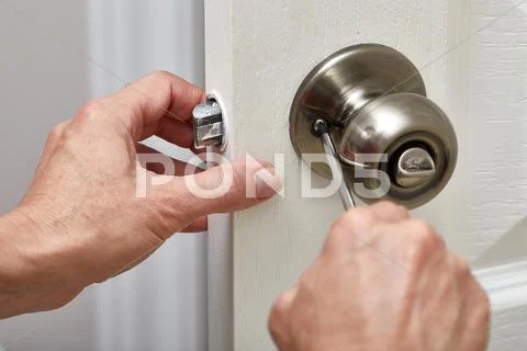 Door knob installation. Stock Photos