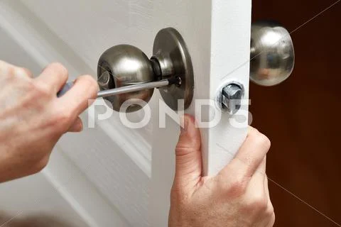 Door knob installation. Stock Photos