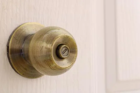 Door knobs on white doors with locks Foto stock