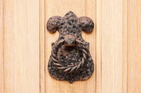 Door knocker and handle on the front door of an old building in Old Town Budv Photos