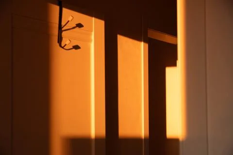 A door with a light shining on it, creating a shadow Stock Photos