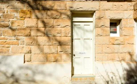 Door marked Private wall old sandstone building. Stock Photos