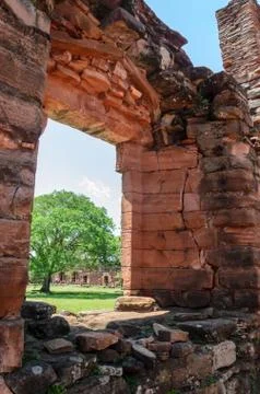 Door of an old building with a background of a tree and other constructions i Stock Photos